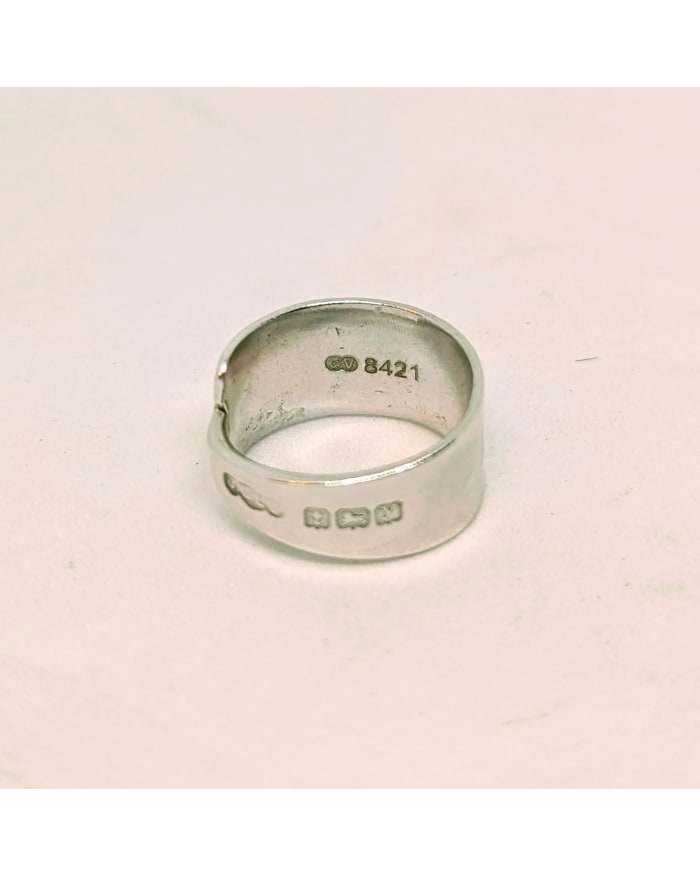 a silver ring with engraved text