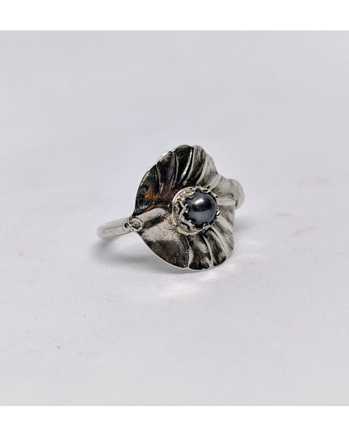 a silver ring with a black stone in the middle