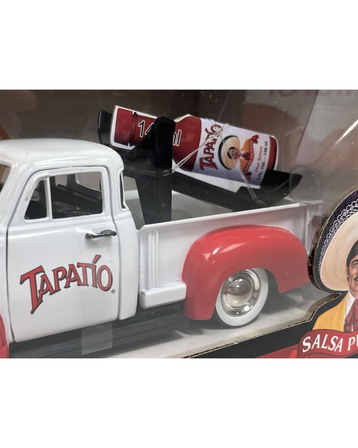 a white truck with a red and white beer in it