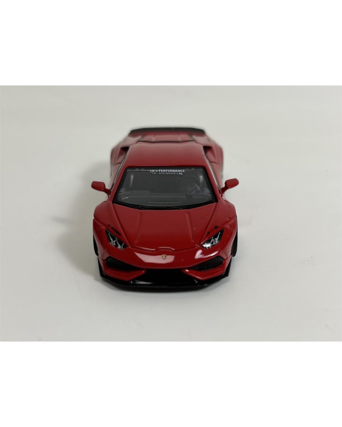 a red toy car on a white surface