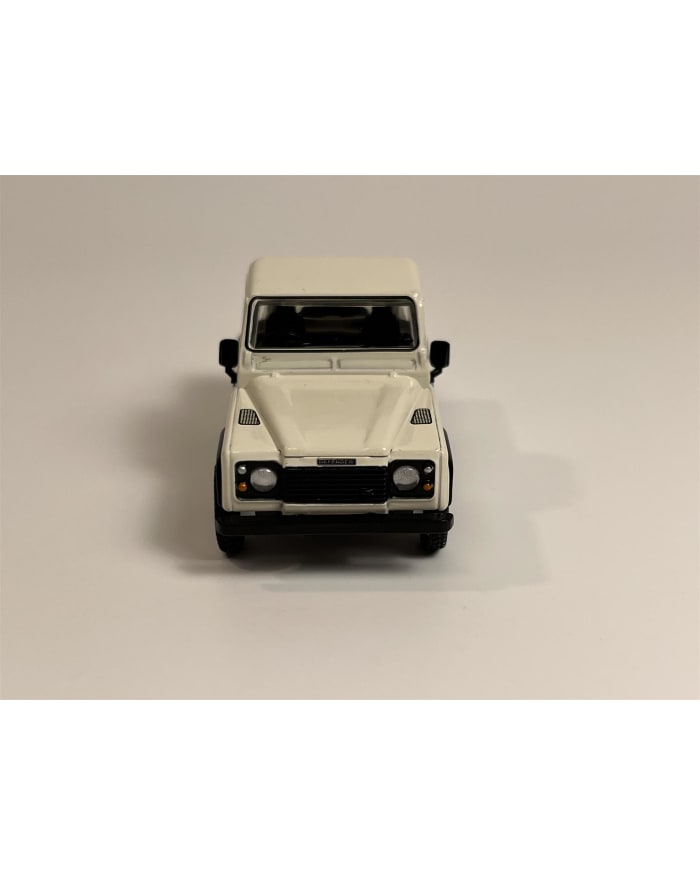 a white toy car on a white background