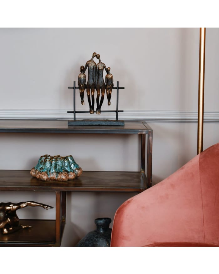 a shelf with a statue of people kissing on it