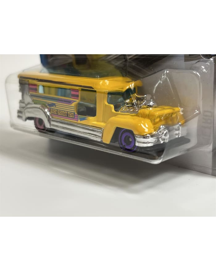 a yellow toy bus in a plastic package