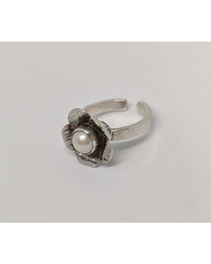 a silver ring with a pearl in the middle