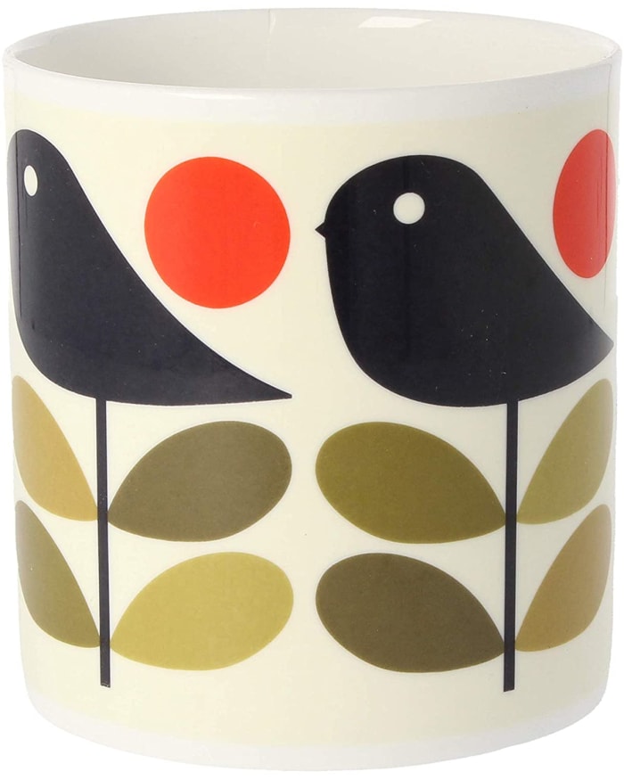 a white cup with birds on it