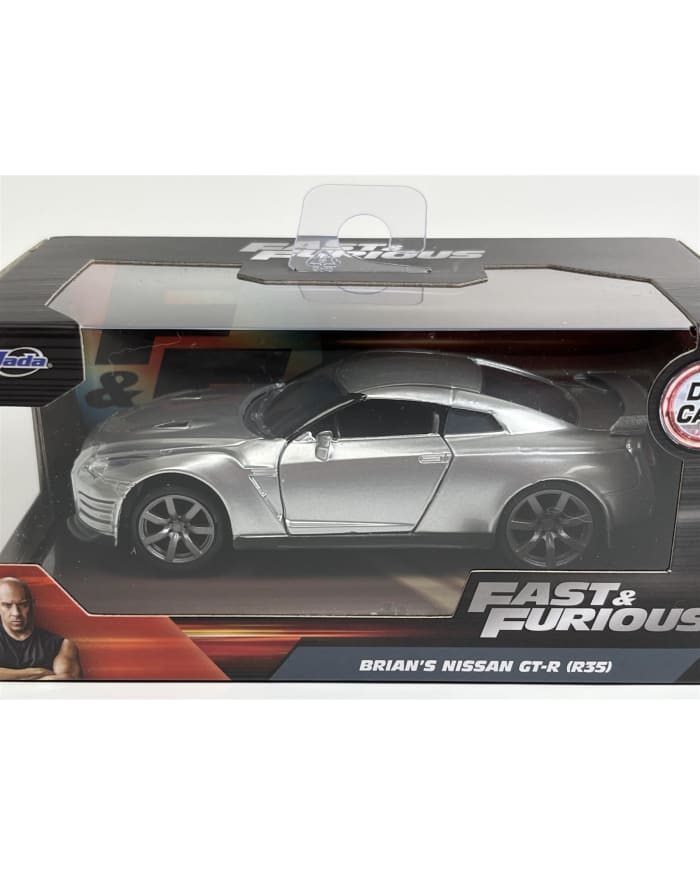 a silver toy car in a box