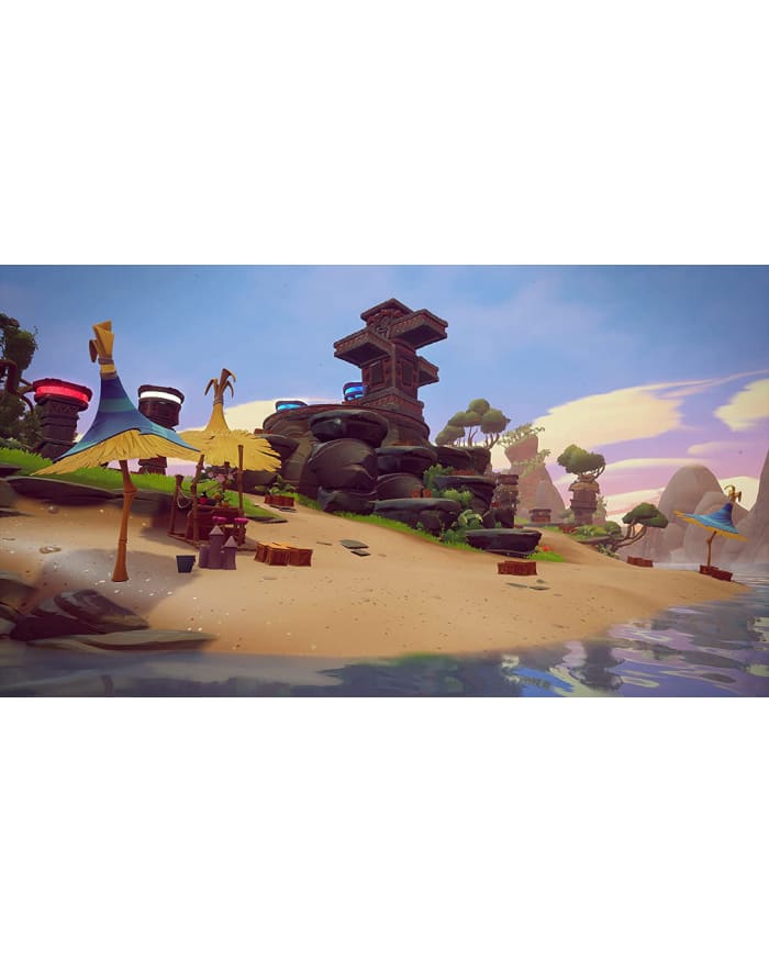 a video game scene of a beach with a building and a water body