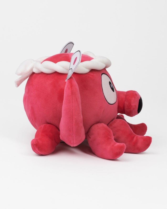 a red stuffed animal with white hair