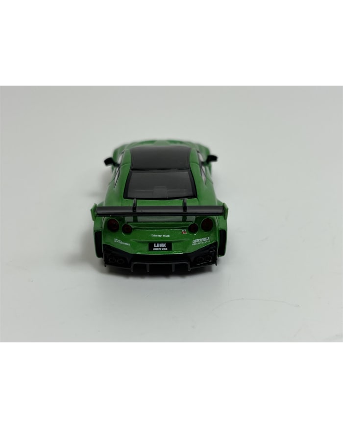 a green toy car on a white surface