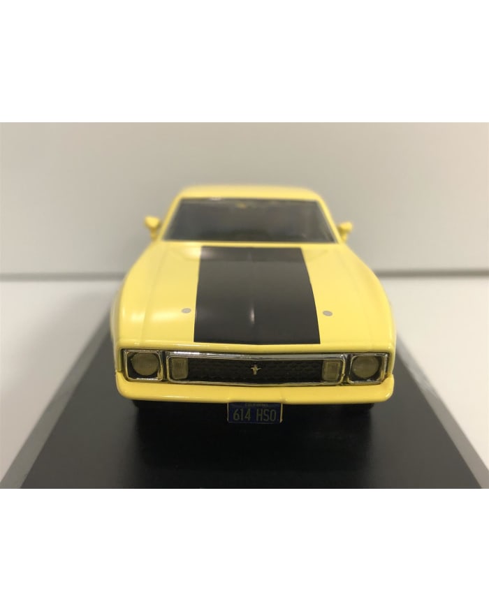 a yellow toy car with black stripes