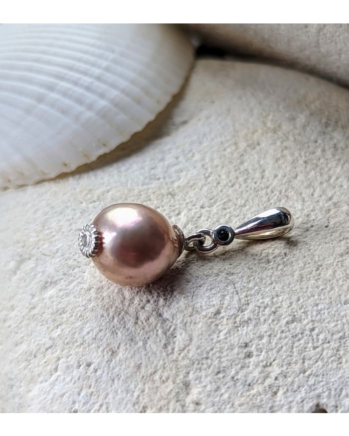 a pearl earring on a rock
