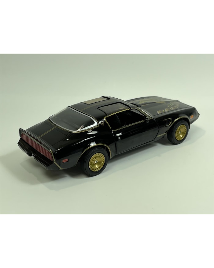 a black toy car with gold rims