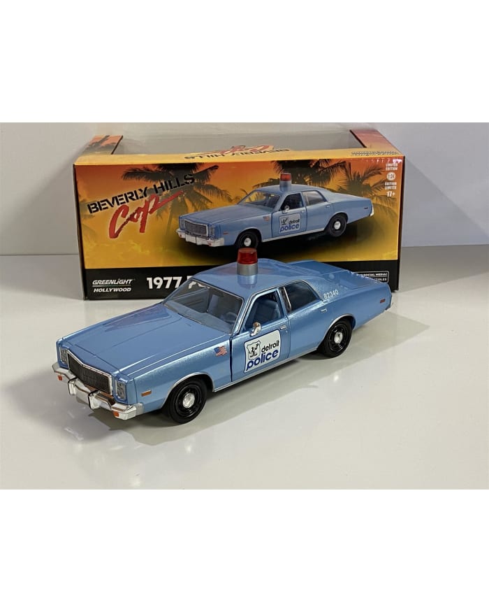 a blue toy car with a light on top and a box