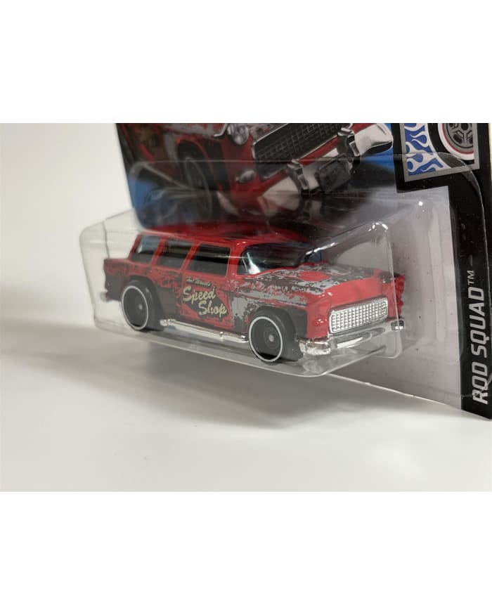 a red toy car in a plastic package