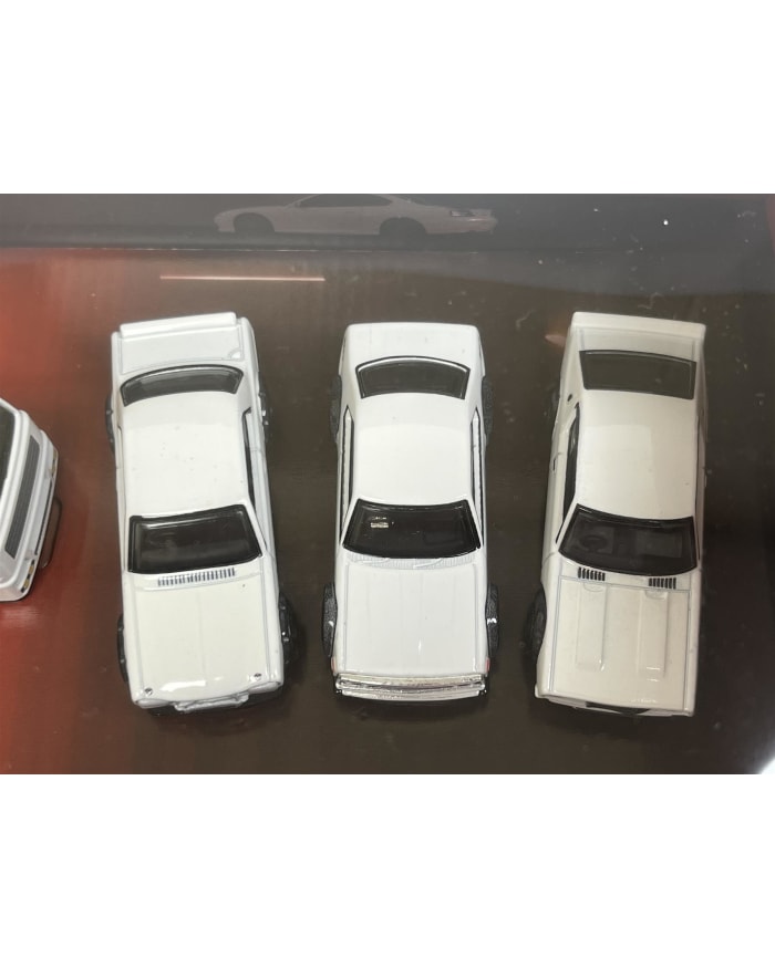 a group of white toy cars