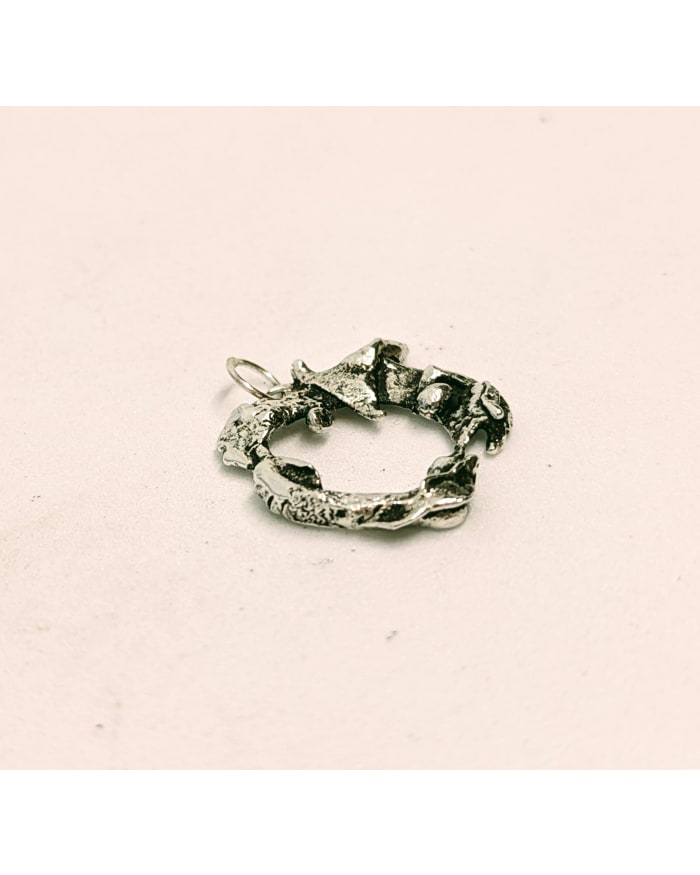 a silver ring on a white surface