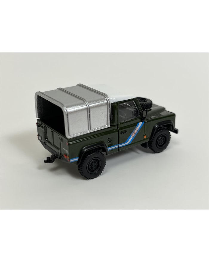 a green toy truck with a silver roof