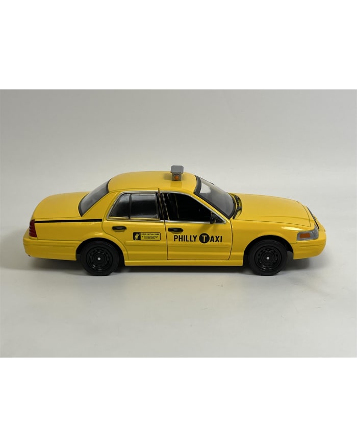 a yellow taxi car with black text