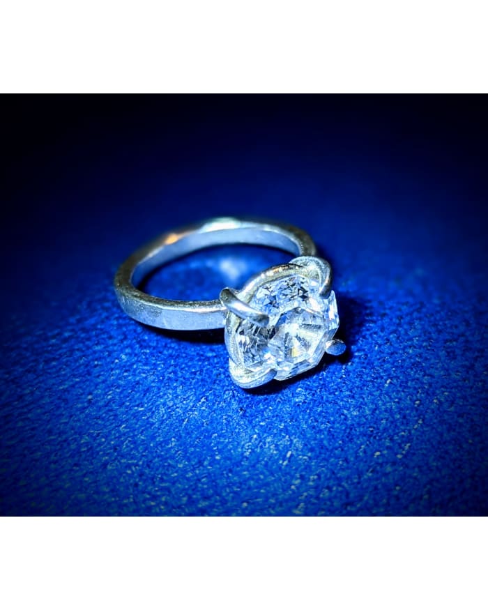 a diamond ring on a blue surface