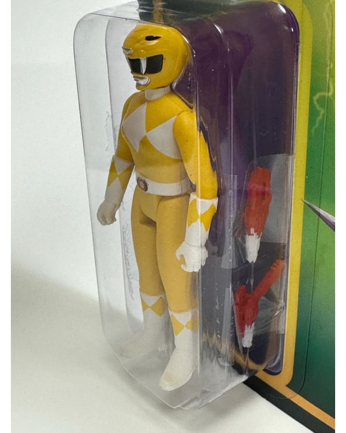 a yellow action figure in a plastic package