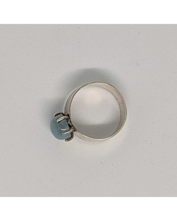 a silver ring with a blue stone on it