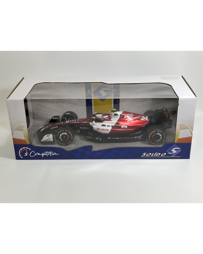 a red and white race car in a plastic box