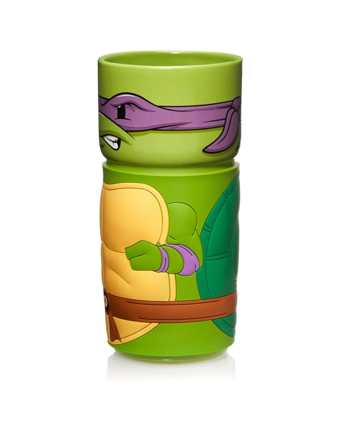 a green mug with a cartoon character on it
