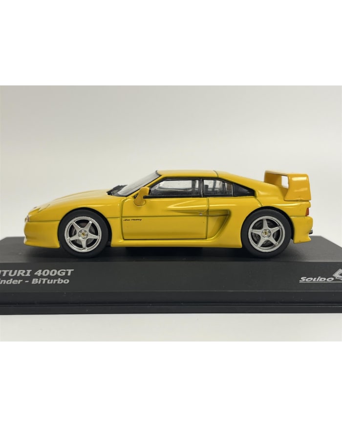a yellow car on a black stand