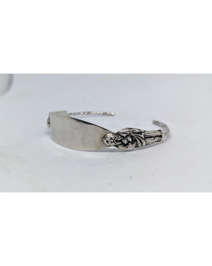 a silver bracelet with a picture on it