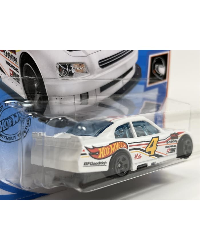 a white toy car in a plastic package