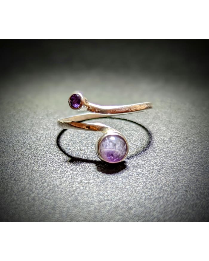 a silver ring with purple stone