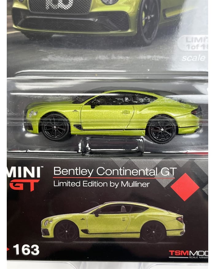 a green toy car in a package