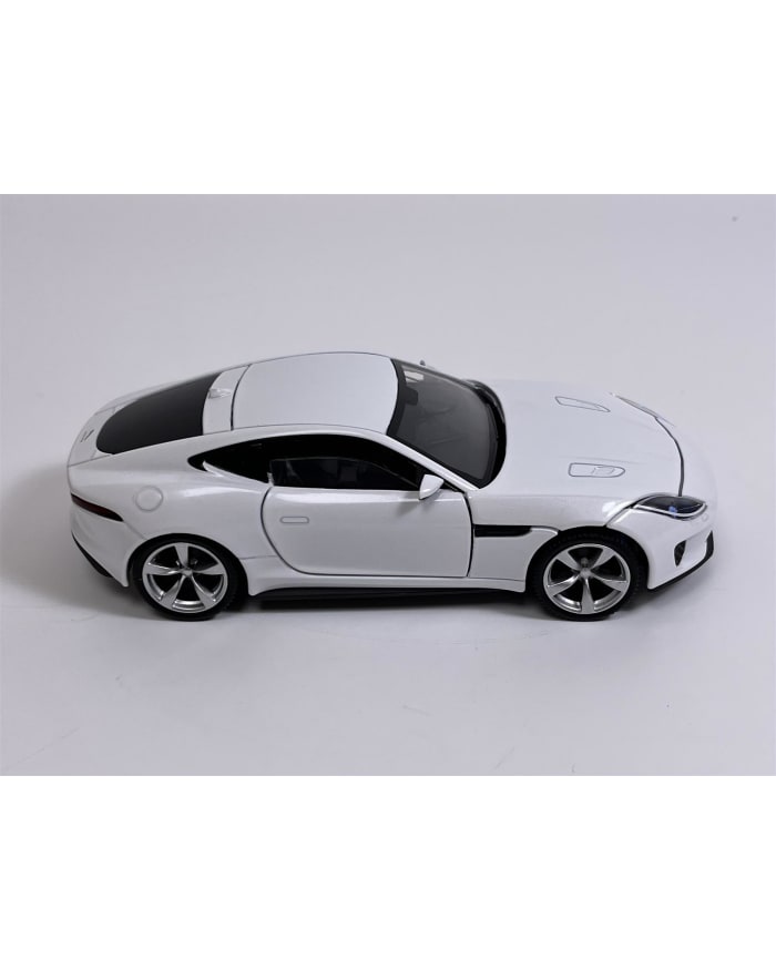a white toy car on a white background