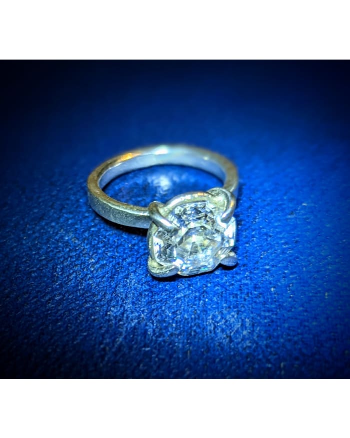 a diamond ring on a blue surface
