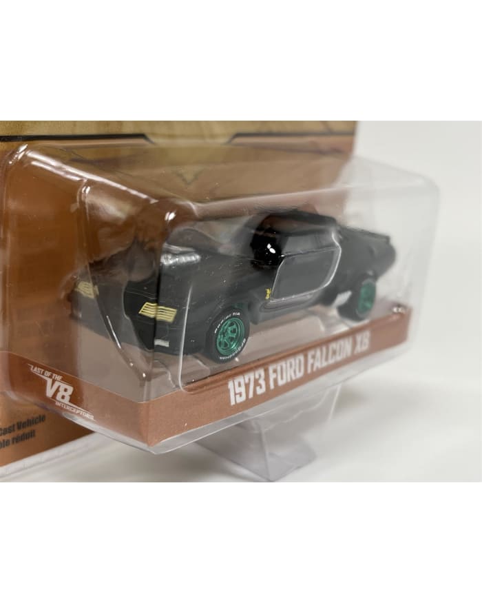 a black toy car in a plastic packaging