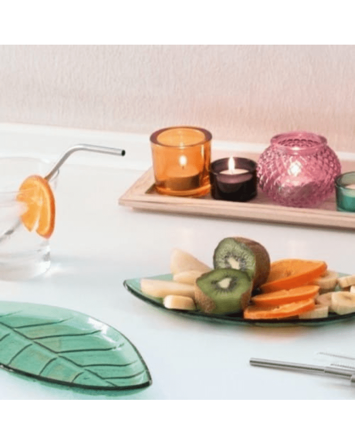 a plate of fruit and candles