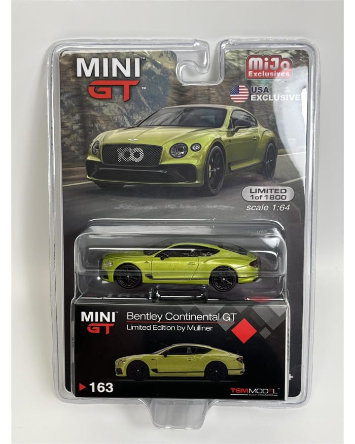 a green toy car in a package