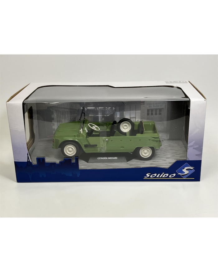 a green toy car in a clear plastic box