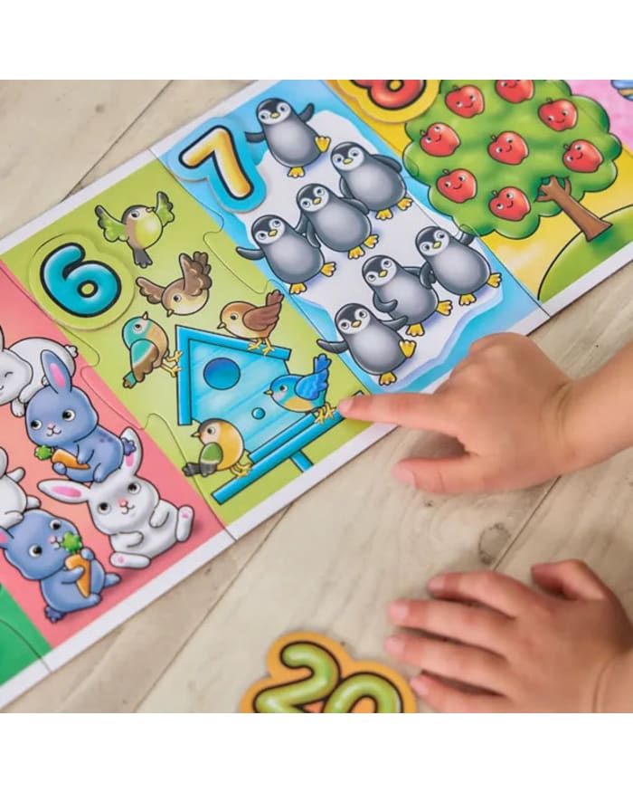 a child's hand pointing at a puzzle