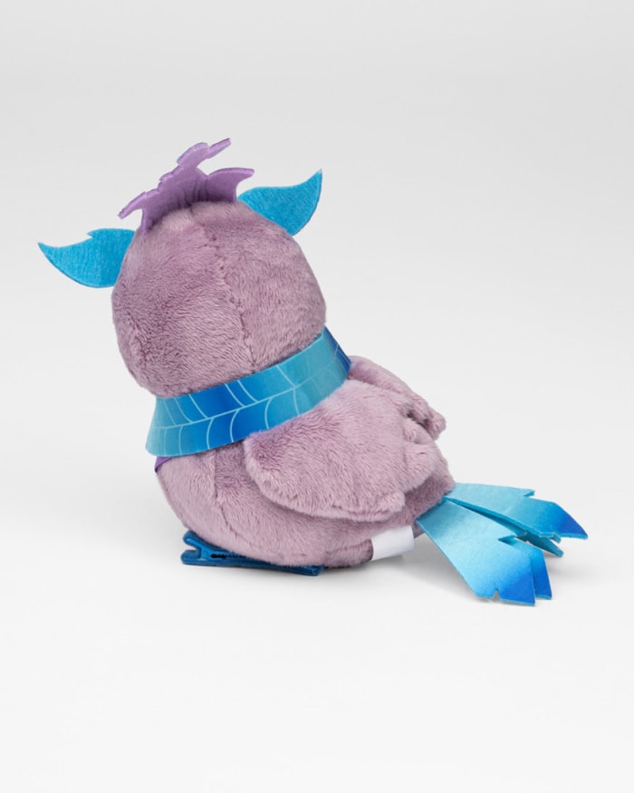 a purple stuffed animal with blue ribbon around its neck