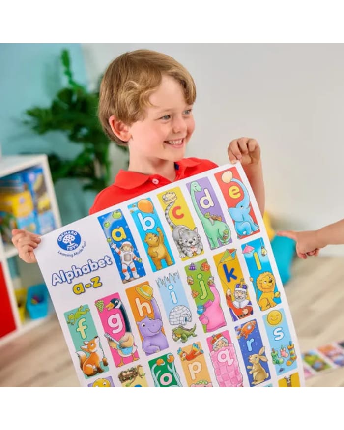 a boy holding a poster with letters