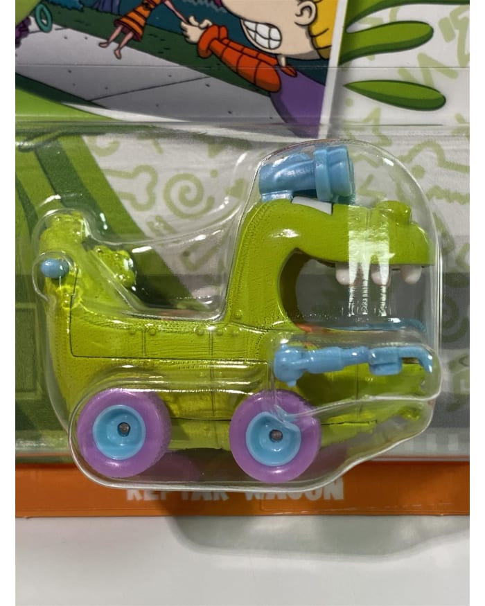 a green toy vehicle in a plastic package