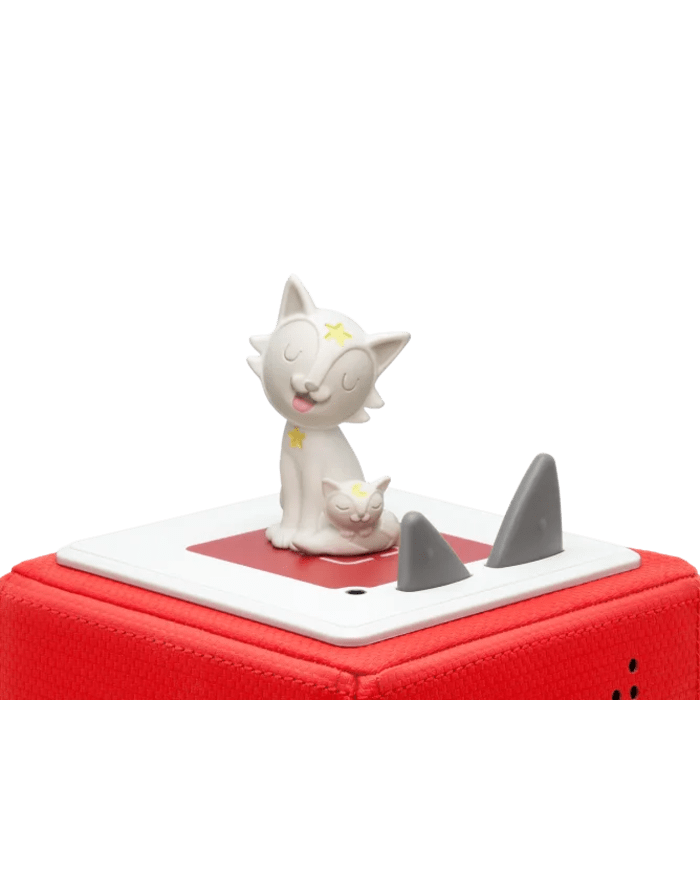 a white cat figurine on a red box