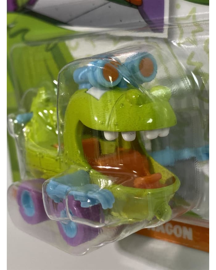 a green plastic toy in a plastic package