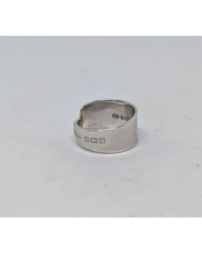 a silver ring with a heart shape design