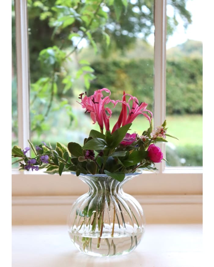 a glass vase with flowers in it