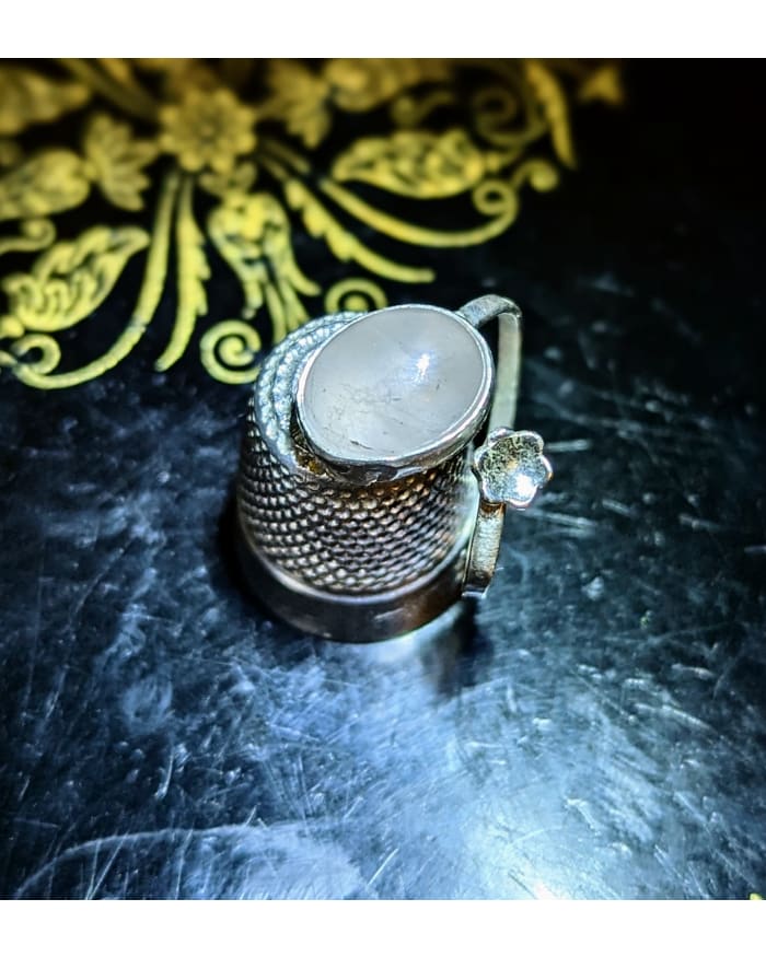 a small metal thimble on a table