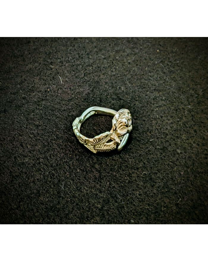 a silver ring on a black surface