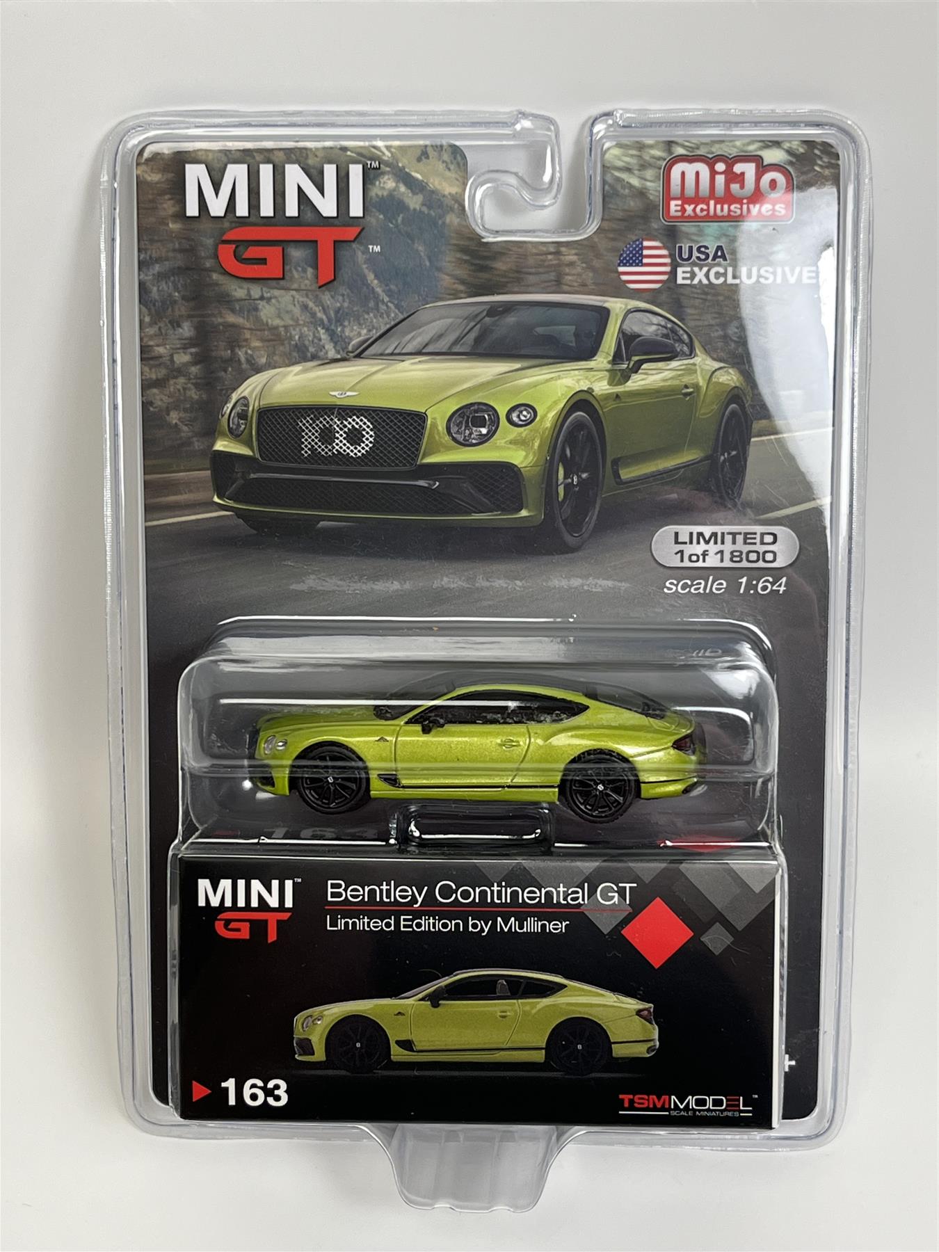 a green toy car in a package