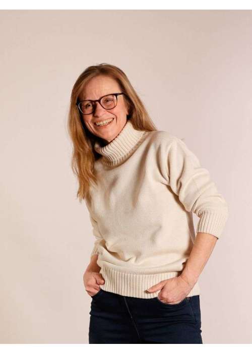 a woman wearing glasses and a white sweater